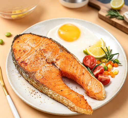 Cooked salmon steak plated with lemon and vegetables